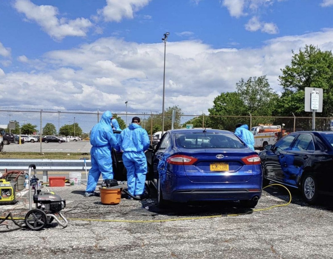 Crew detailing sedans on-site
